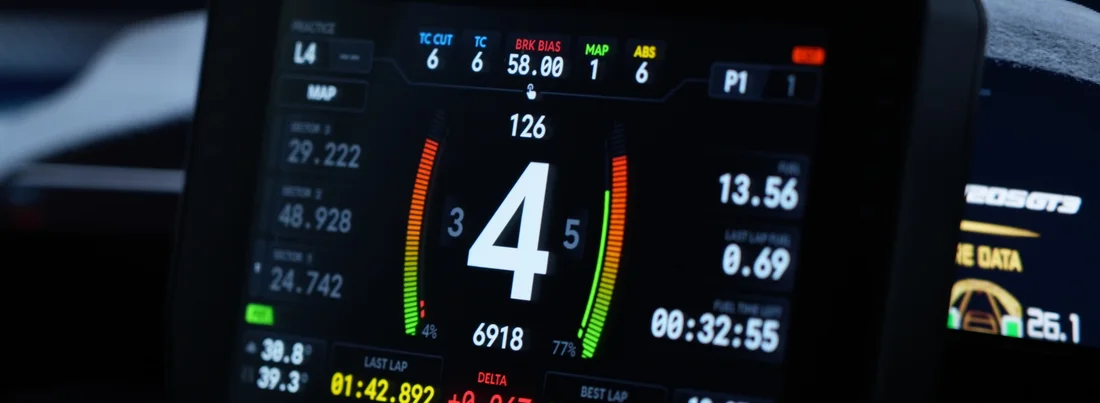 Cockpit photo: the dashboard live on the car's screen, showing gear 4, speed, lap times and delta.